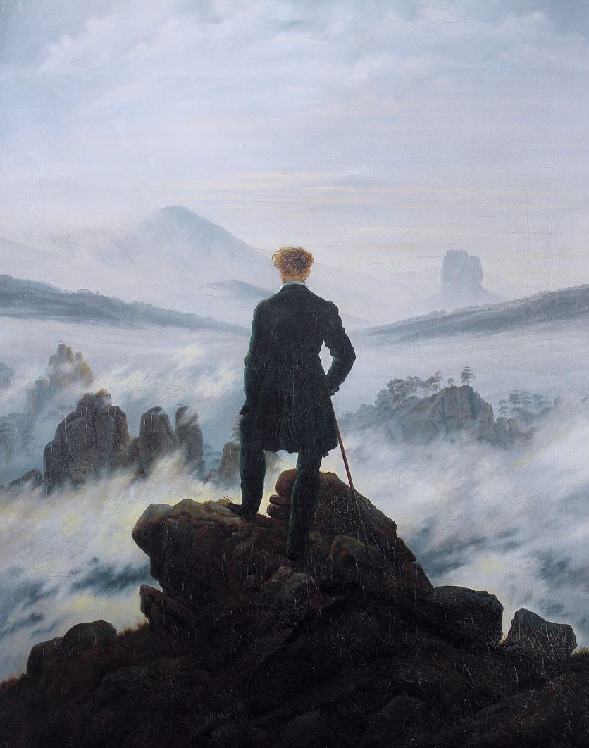 A person standing on a rock Description automatically generated with medium confidence